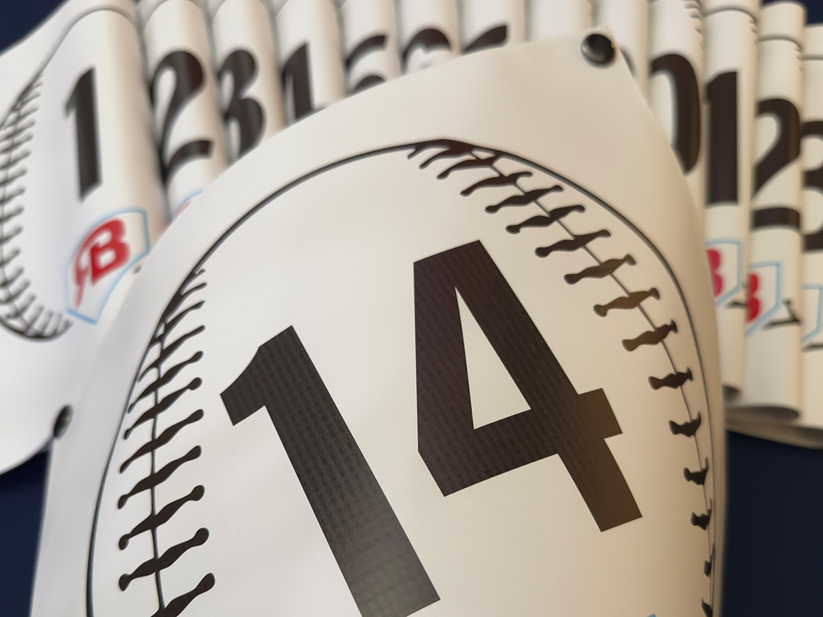 Bulk order of baseball field number snap-on banners ready for tournament deployment
