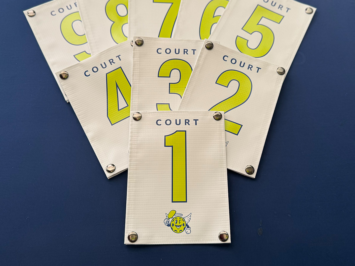 Fanned display of court ID banners numbered 1 through 9 in lime green and white vinyl